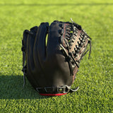 All black with red accent closed back semi-custom baseball glove. The Phantom, set on a turf baseball field